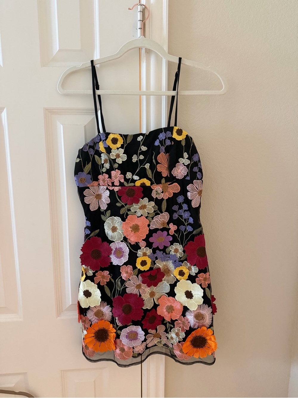 Storia black mini dress with floral appliqué